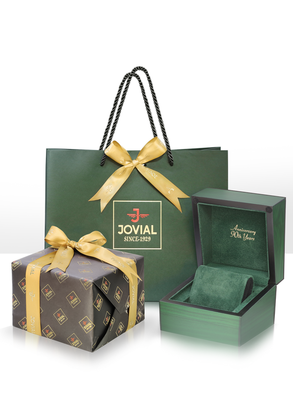 Green gift bag, box, and packaging with gold ribbons featuring the Jovial brand on a white background.